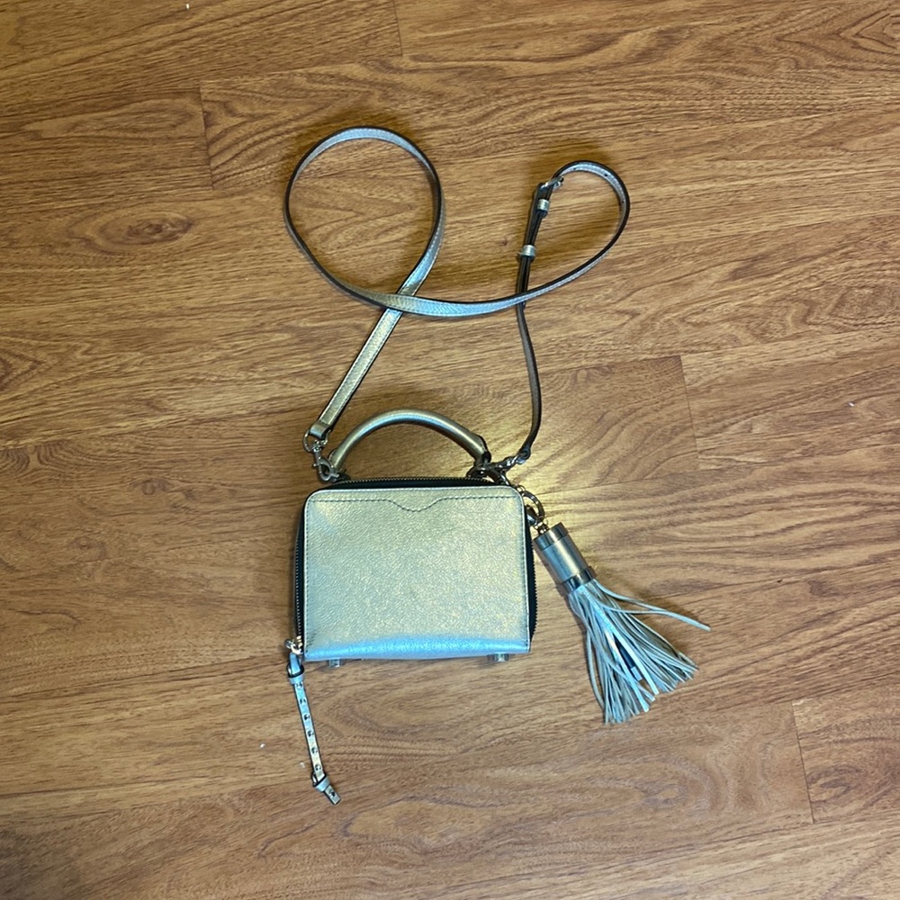 Silver Rebecca Minkoff bag with phone charger tassel